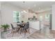 Dining area with modern light fixture and view into the kitchen at 1514 Starmount Cove Ln, Charlotte, NC 28210