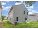 The home's backyard is grassy, showing the siding and door at 1514 Starmount Cove Ln, Charlotte, NC 28210