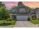 Charming two-story home with a manicured lawn and two car garage at 1514 Starmount Cove Ln, Charlotte, NC 28210
