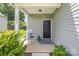 Inviting front porch with rocking chair, black door, and decorative rug at 1514 Starmount Cove Ln, Charlotte, NC 28210
