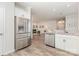 Modern kitchen with stainless appliances and stone countertops open to living area at 1514 Starmount Cove Ln, Charlotte, NC 28210