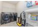 This laundry room is complete with appliances and shelving for storage at 1514 Starmount Cove Ln, Charlotte, NC 28210