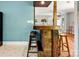 Rustic wooden bar with barstool seating connects the living room and kitchen spaces at 1617 Madison St, Rock Hill, SC 29732