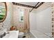 Bathroom with floral wallpaper, tub, toilet, vanity and small window at 1617 Madison St, Rock Hill, SC 29732