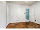 Bedroom featuring hardwood floors, white walls, and a door leading to another room at 1617 Madison St, Rock Hill, SC 29732