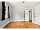 Bedroom featuring hardwood floors, light gray walls, and windows with black curtains at 1617 Madison St, Rock Hill, SC 29732