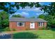 Traditional brick home with lush lawn, mature landscaping and a charming front entrance at 1617 Madison St, Rock Hill, SC 29732