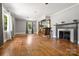 Bright living room featuring hardwood floors, fireplace, and wooden bar with stools at 1617 Madison St, Rock Hill, SC 29732