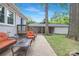 Cozy outdoor patio with comfortable seating, firepit, and view of a detached structure with a covered sitting area at 1744 Emerywood Dr, Charlotte, NC 28210