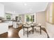 A bright dining area with table, chairs, and natural light, seamlessly flowing into the kitchen at 1744 Emerywood Dr, Charlotte, NC 28210