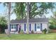 Quaint single story home with a well kept lawn, tasteful landscaping, and patriotic flag at 1744 Emerywood Dr, Charlotte, NC 28210