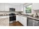 Well-lit kitchen with granite countertops, stainless steel appliances, and ample storage space at 1744 Emerywood Dr, Charlotte, NC 28210