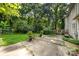 Backyard with trees, a patio area, and a staircase leading to a deck at 204 S Deerfield Cir, Salisbury, NC 28147