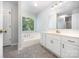 Bathroom includes a bathtub, vanity with sink, and large mirror at 204 S Deerfield Cir, Salisbury, NC 28147