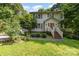 Two-story home featuring mature trees, a garden and a well-manicured front lawn at 204 S Deerfield Cir, Salisbury, NC 28147