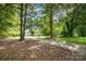 Exterior home view with a long driveway and trees surrounding the house at 204 S Deerfield Cir, Salisbury, NC 28147