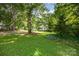 Well-manicured front yard with mature trees and lush green grass surround a two-story house at 204 S Deerfield Cir, Salisbury, NC 28147