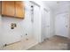 A laundry room with overhead cabinets and tile flooring at 204 S Deerfield Cir, Salisbury, NC 28147