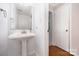 Cozy powder room with pedestal sink and a view into the entry hallway at 204 S Deerfield Cir, Salisbury, NC 28147
