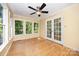 A sunroom featuring hardwood floors, lots of natural light, and a ceiling fan at 204 S Deerfield Cir, Salisbury, NC 28147