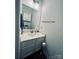A well-lit bathroom features a modern vanity, mirror, and fixtures at 222 Ross Moore Ave, Charlotte, NC 28205
