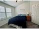 Well-lit bedroom with a ceiling fan, window, and closet space at 222 Ross Moore Ave, Charlotte, NC 28205