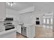 Open kitchen with stainless steel appliances seamlessly flows into the living space, ideal for entertaining at 222 Ross Moore Ave, Charlotte, NC 28205