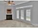 Bright living room features a fireplace, ceiling fan, and access to an outdoor patio at 222 Ross Moore Ave, Charlotte, NC 28205