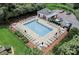 Aerial view of a community pool surrounded by lounge chairs and lush greenery at 222 Ross Moore Ave, Charlotte, NC 28205