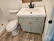 Bathroom featuring a gray vanity with white countertops, a toilet, and wood-look floors at 2448 Cambridge Dr, Lancaster, SC 29720