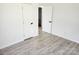 Bright bedroom showcasing hardwood floors and multiple doorways at 2448 Cambridge Dr, Lancaster, SC 29720