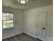 A tidy bedroom with vinyl floors, a window, and a door at 2448 Cambridge Dr, Lancaster, SC 29720