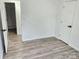 Neutral bedroom featuring new vinyl floors and a view to an en-suite bathroom at 2448 Cambridge Dr, Lancaster, SC 29720