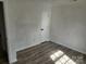 Sunny bedroom with new vinyl floors, base trim, and a doorway to a hallway at 2448 Cambridge Dr, Lancaster, SC 29720