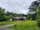 Inviting single-story brick home with a well-kept lawn and mature trees at 2448 Cambridge Dr, Lancaster, SC 29720