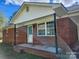 Cozy single-story brick home featuring a covered entrance and adjacent parking area at 2448 Cambridge Dr, Lancaster, SC 29720