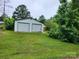 Spacious two-car detached garage with ample green space and mature trees at 2448 Cambridge Dr, Lancaster, SC 29720