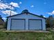 Detached two-car garage with clean siding and green surroundings on a sunny day at 2448 Cambridge Dr, Lancaster, SC 29720