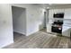 Clean and modern kitchen with stainless steel appliances and white cabinets adjacent to a living area at 2448 Cambridge Dr, Lancaster, SC 29720