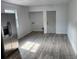 Spacious area with stainless steel refrigerator and wood floors, adjacent to a utility area at 2448 Cambridge Dr, Lancaster, SC 29720