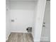 Utility area features wood floors, connections, and a white door to the home's exterior at 2448 Cambridge Dr, Lancaster, SC 29720