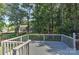 Backyard deck overlooking a lush green area with many mature trees providing shade at 2706 Bremer Ct, Charlotte, NC 28210