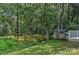 The backyard contains a small stream, shed, and lush landscaping at 2706 Bremer Ct, Charlotte, NC 28210