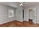 Bedroom with a ceiling fan, wood floors, closet and a door to an ensuite bathroom at 2706 Bremer Ct, Charlotte, NC 28210