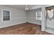 Cozy bedroom with a ceiling fan, natural light, hardwood floors, and an ensuite bathroom at 2706 Bremer Ct, Charlotte, NC 28210