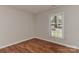 Empty bedroom features natural light and hardwood floors at 2706 Bremer Ct, Charlotte, NC 28210