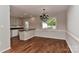 Bright dining room with hardwood floors, updated lighting, and a view to the exterior at 2706 Bremer Ct, Charlotte, NC 28210