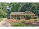 Charming single story home featuring a cozy front porch and mature trees at 2706 Bremer Ct, Charlotte, NC 28210