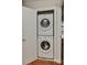 Modern laundry closet with stacked washer and dryer in a white-trimmed alcove at 2706 Bremer Ct, Charlotte, NC 28210