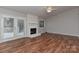 Spacious living room with hardwood floors, fireplace, and outdoor access at 2706 Bremer Ct, Charlotte, NC 28210